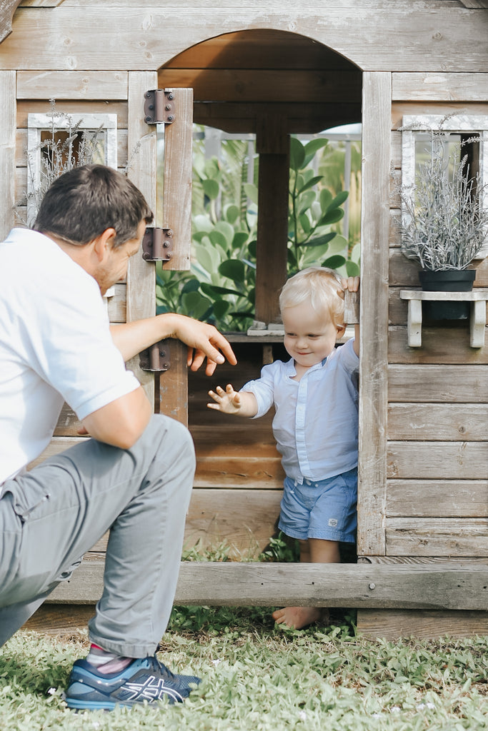 father and toddler son playing outdoors